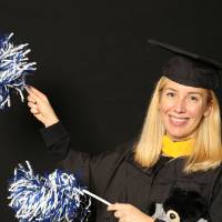 woman takes a funny picture with the pom poms
